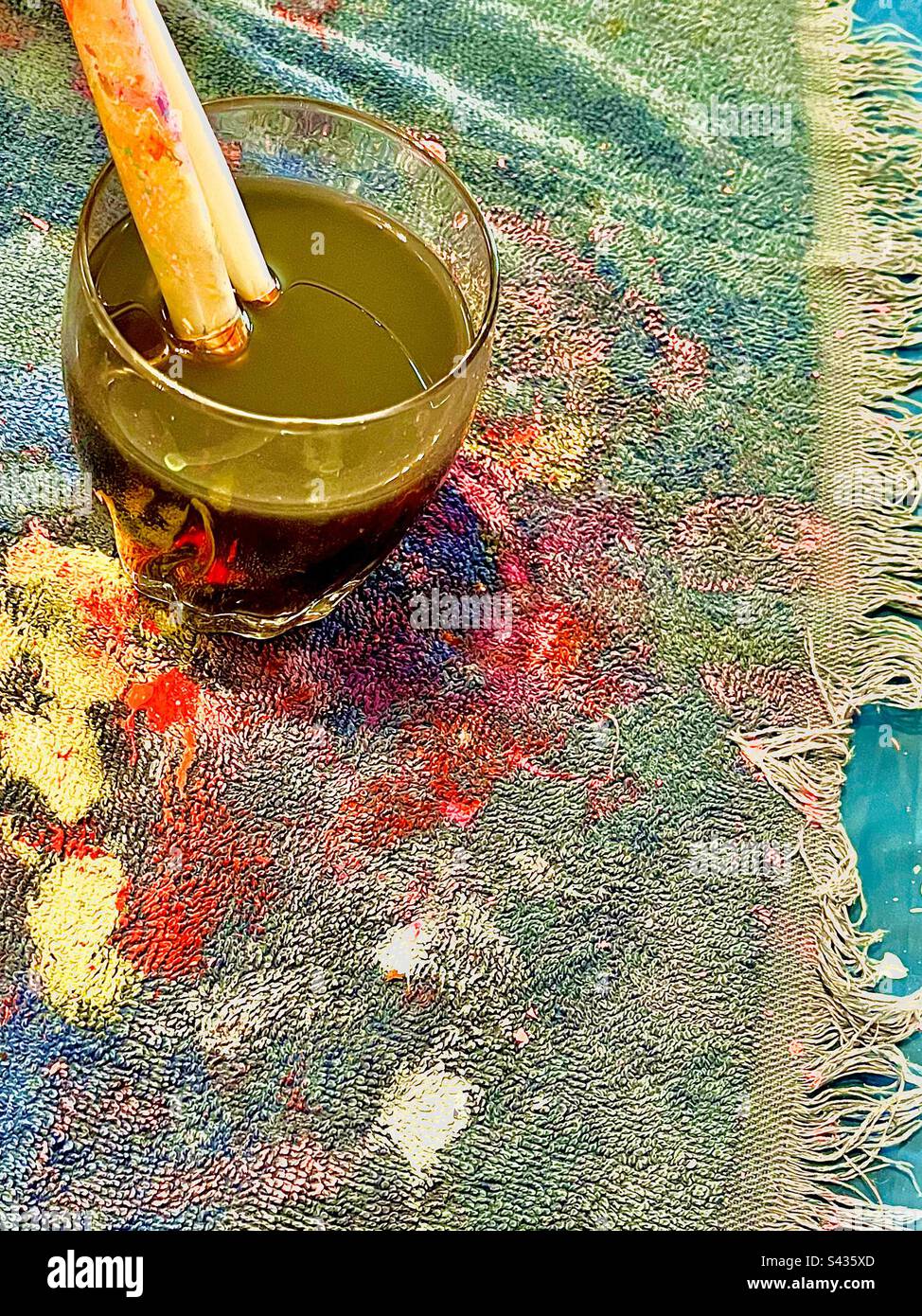 Artists drop cloth messy with colorful paint splatter. Two soaking paintbrushes in upper right corner. Includes print space. - Smartphone Captured Stock Image