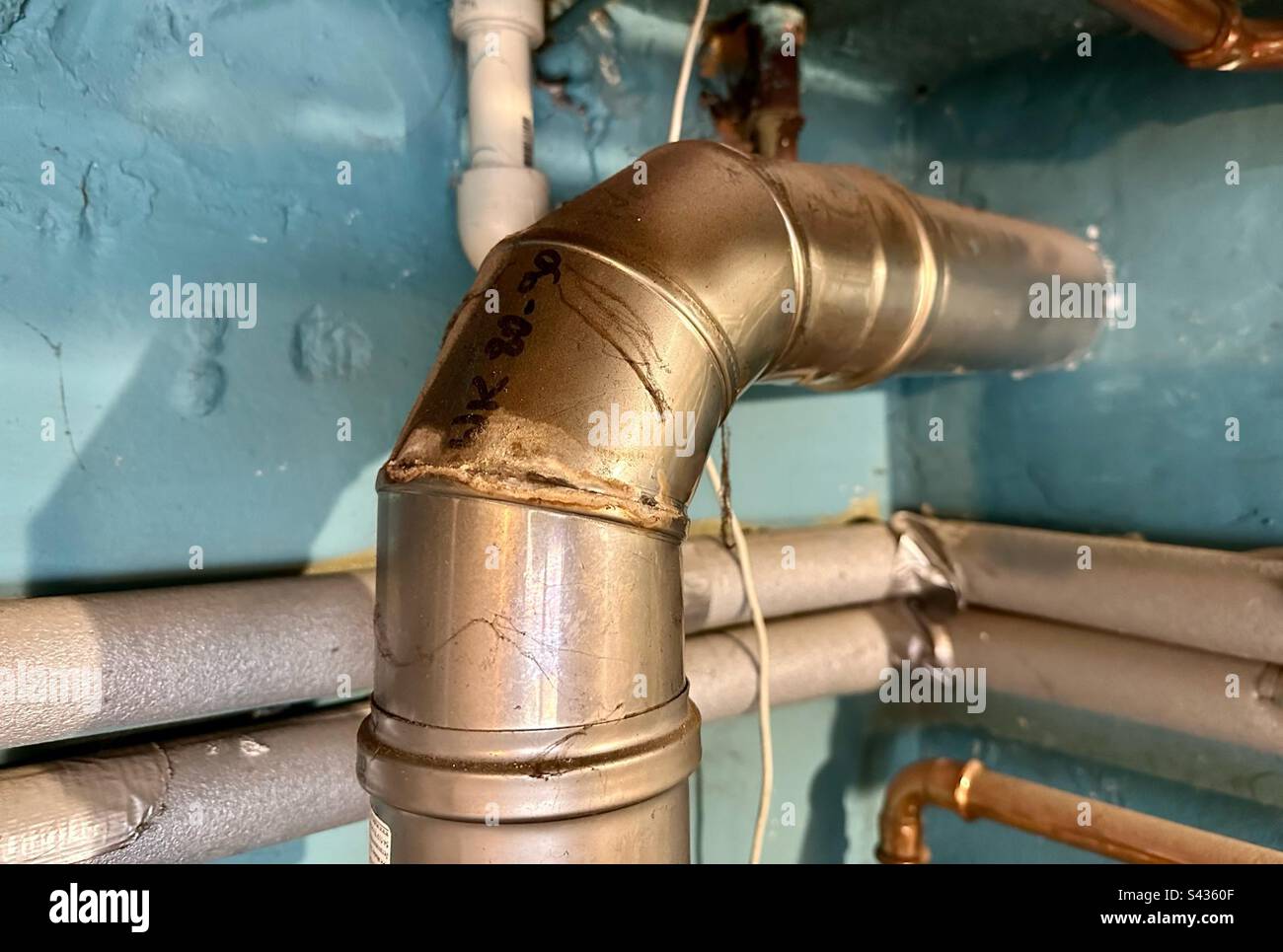 damaged stainless steel chimney pipe carrying flue gas from the gas