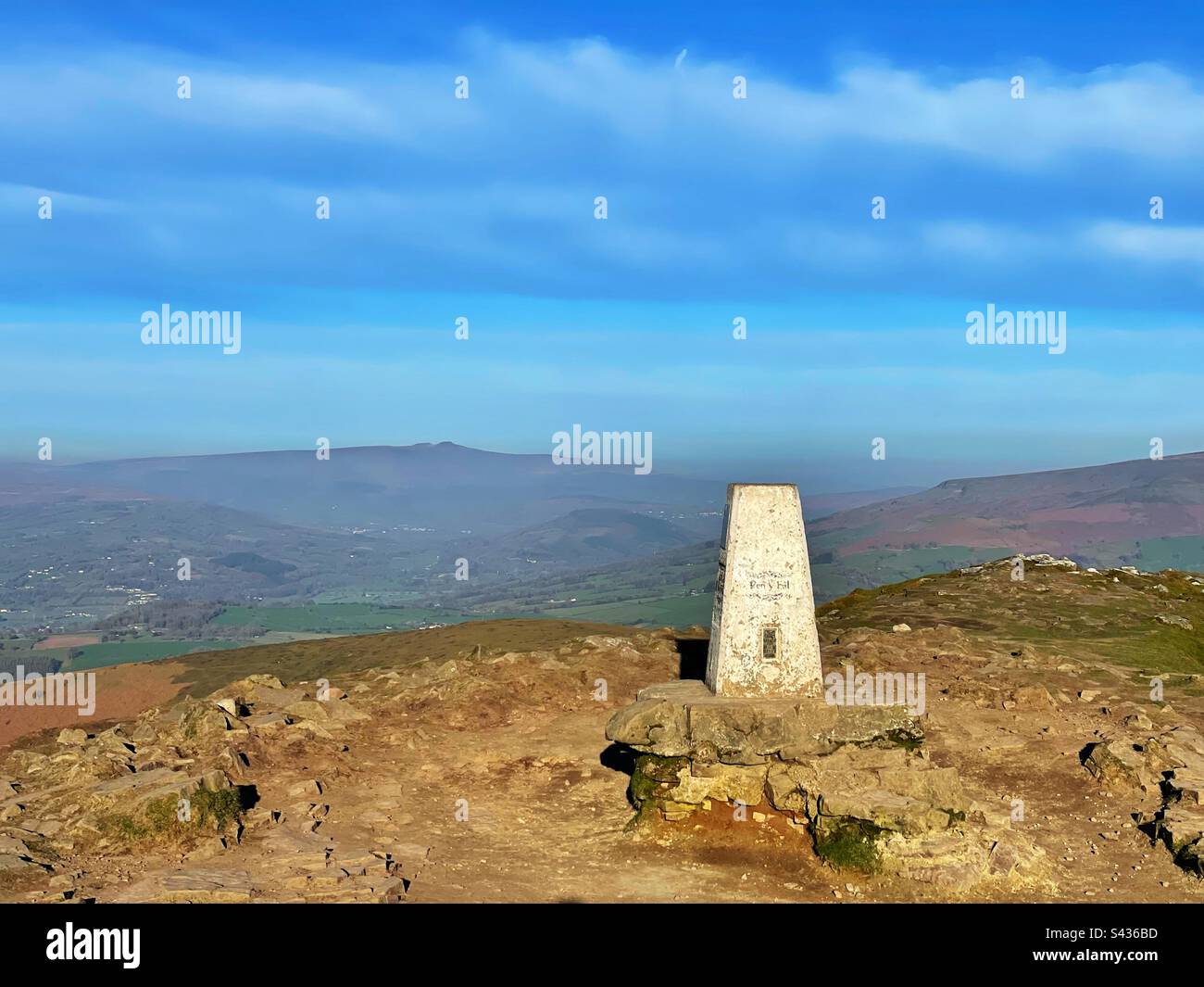 Trig point of Sugarloaf mountain, Brecon Beacons, Abergavenny, Wales. Pen y Fan and Corn Du visible in the background. - Smartphone Captured Stock Image