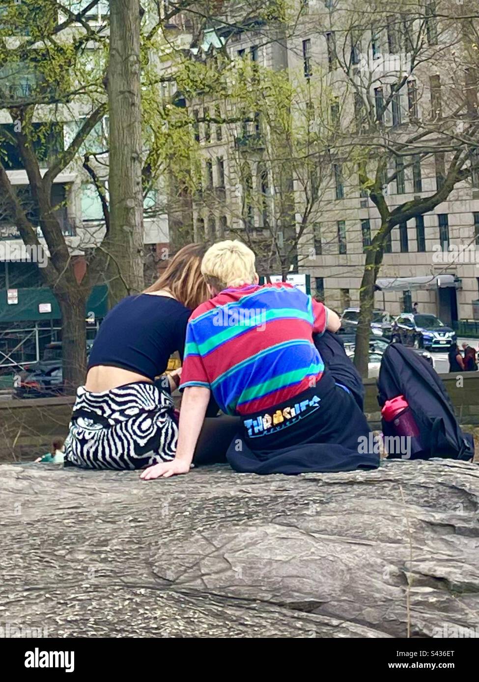 A couple canoodling in a city park - Smartphone Captured Stock Image