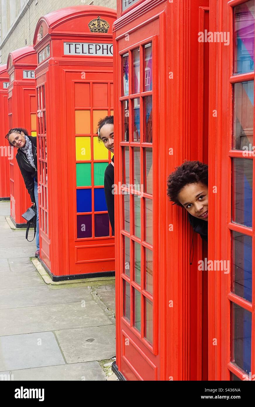 Family and telephone boxes. - Smartphone Captured Stock Image