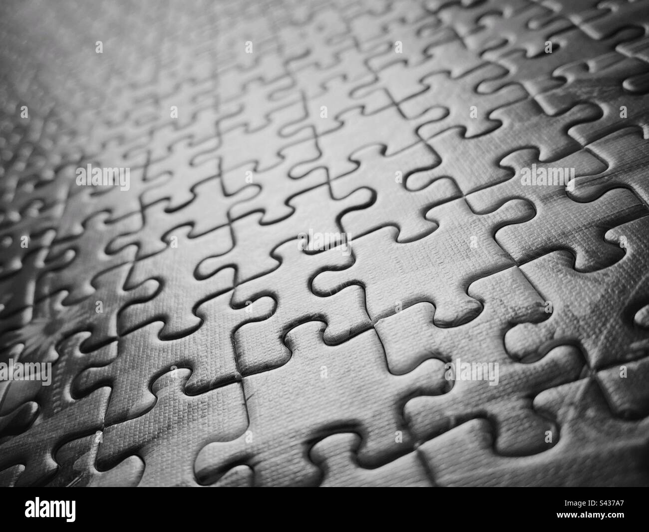 A close up photograph of jigsaw pattern in black and white - Smartphone Captured Stock Image