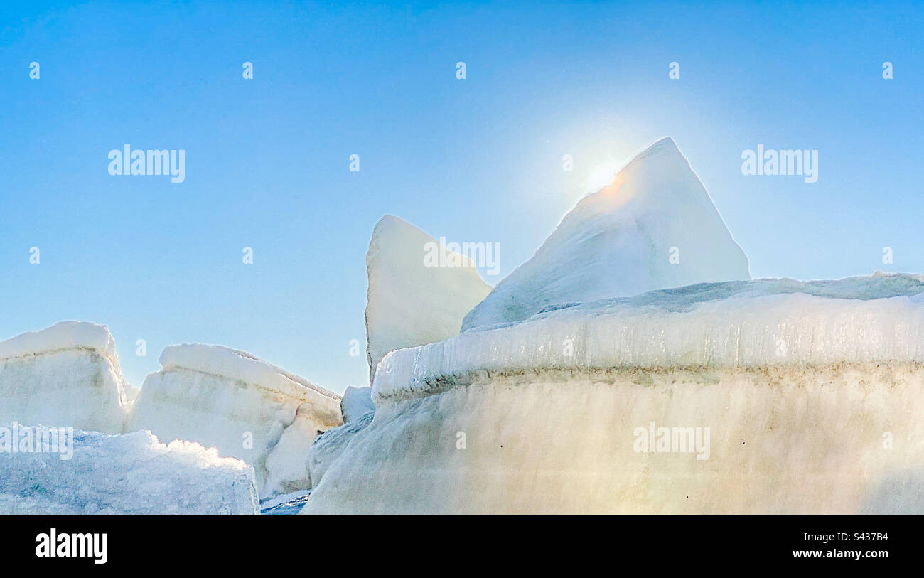 Breached ice floes jammed up into piles from the annual break up of the river and sea ice during the spring melt in the Alaskan arctic town of Kotzebue - Smartphone Captured Stock Image