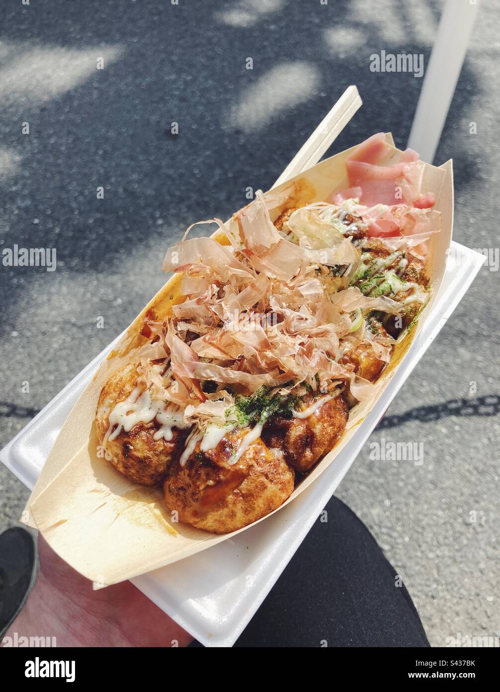 Takoyaki, pancake batter balls filled with octopus and topped with a brown sauce, mayonnaise and