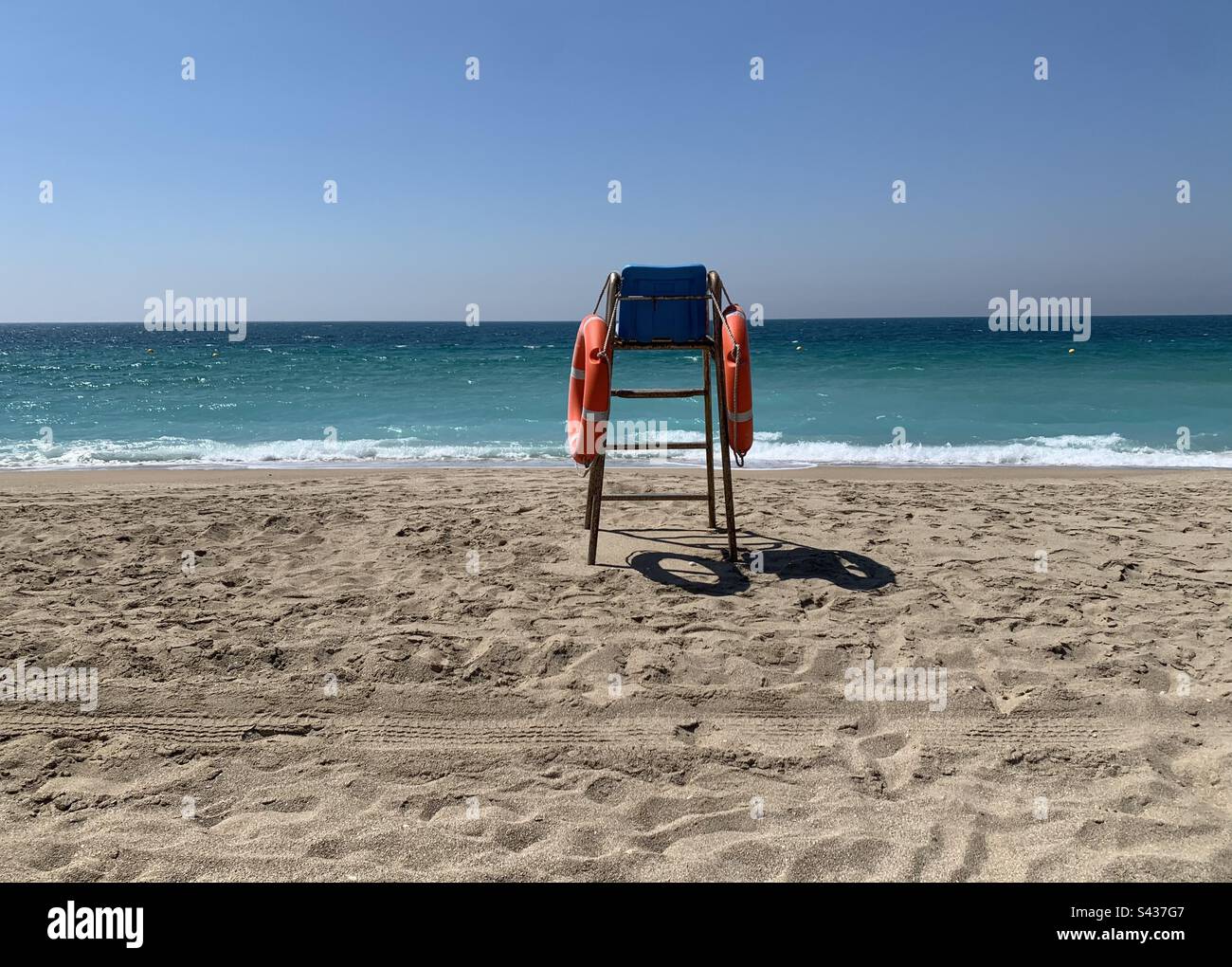 Lifeguard chair on a deserted beach on a sunny spring morning - Smartphone Captured Stock Image