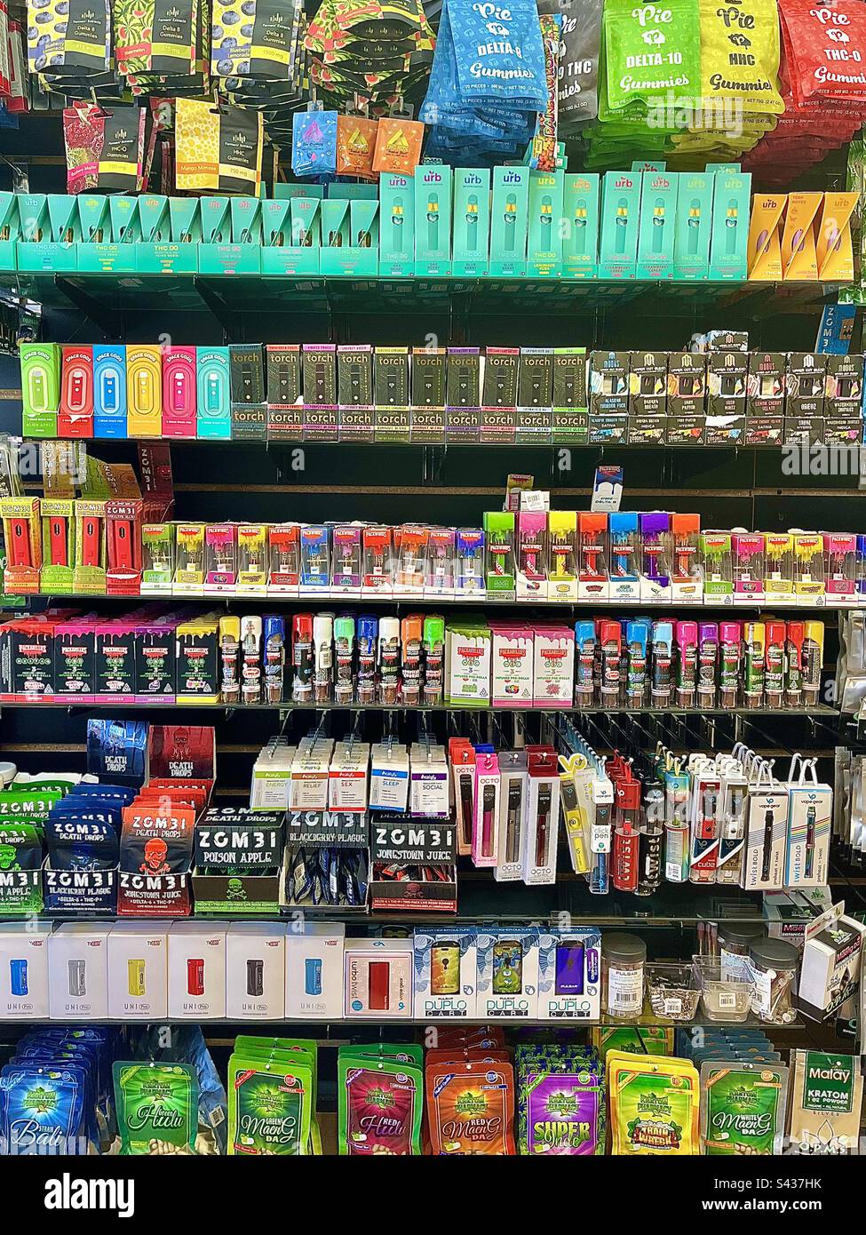 Colorful product display wall in smoke shop fills entire frame. Stock Photo