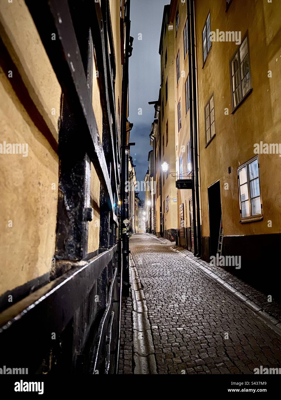 Night time on the beautiful but spooky narrow cobbled streets of Stockholm Old Town Gamla Stan in Sweden - Smartphone Captured Stock Image