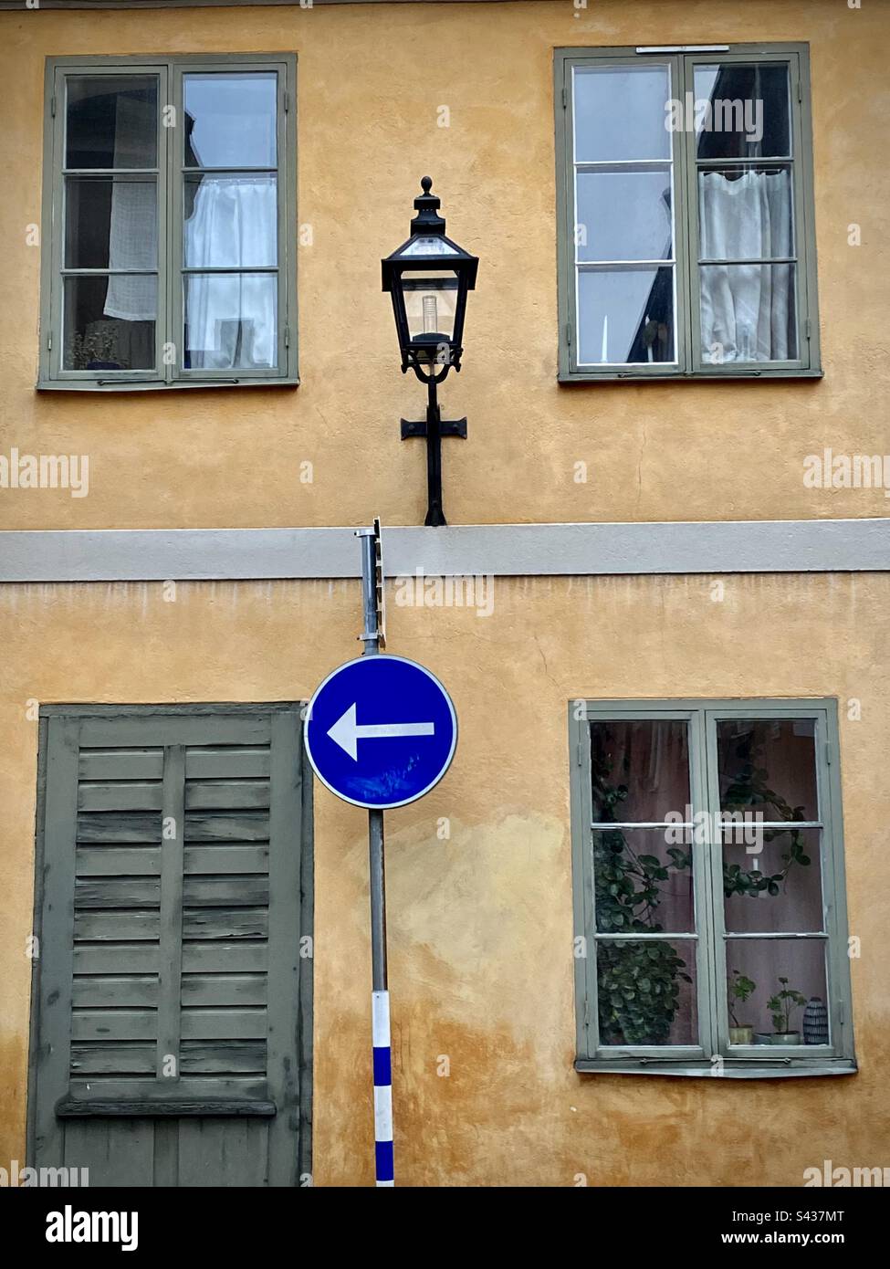 House details of the beautiful shadowy orange and yellow painted exteriors of traditional buildings on the narrow streets of Stockholm Old Town Gamla Stan in Sweden - Smartphone Captured Stock Image