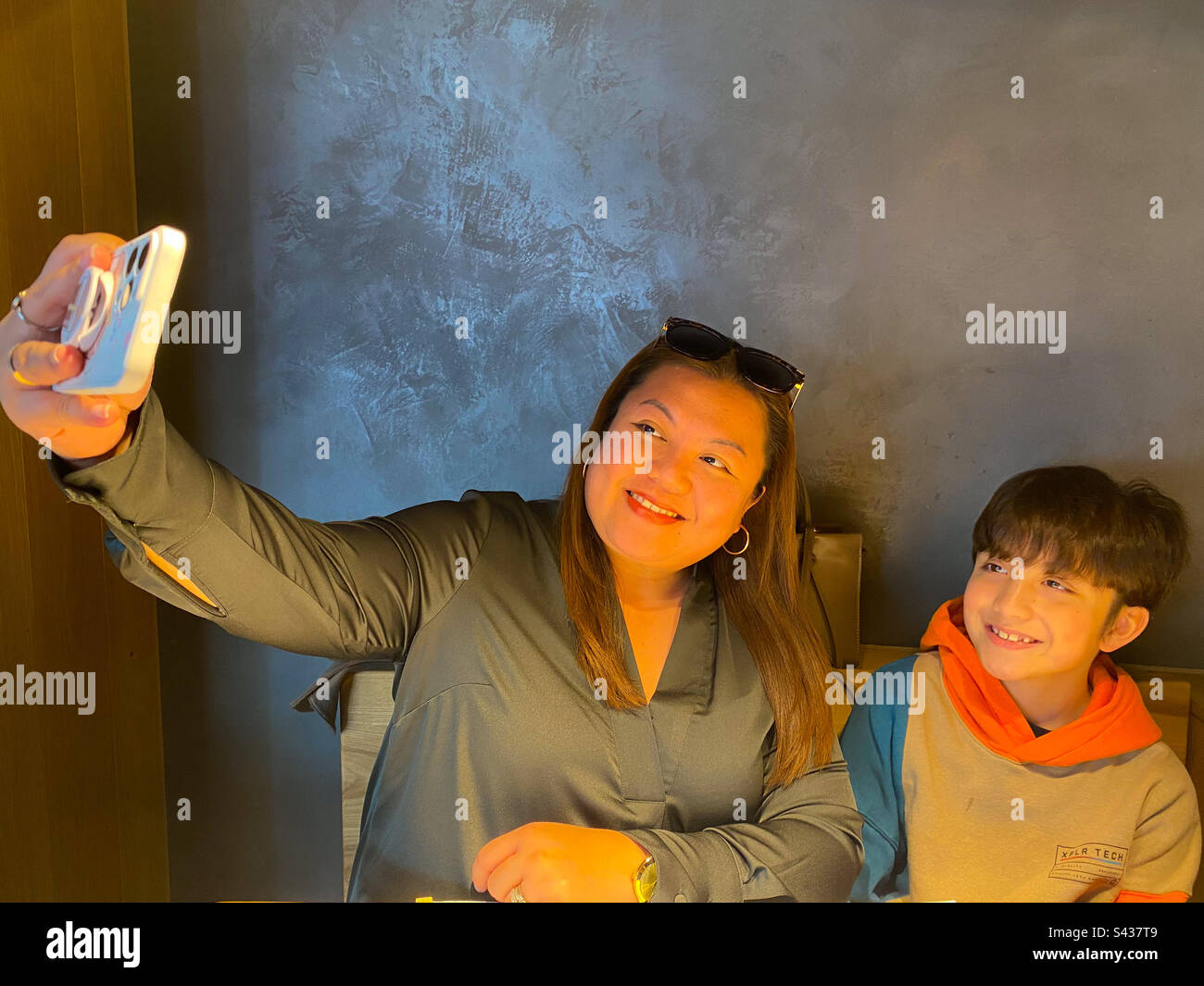 Mother and son taking a selfie together on a mobile phone. - Smartphone Captured Stock Image