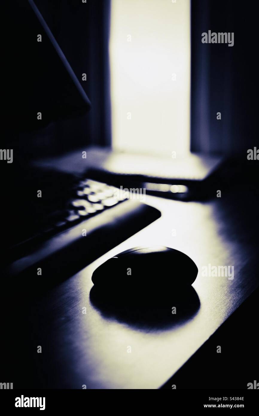 A mouse and keyboard at a home office in the sunlight - Smartphone Captured Stock Image