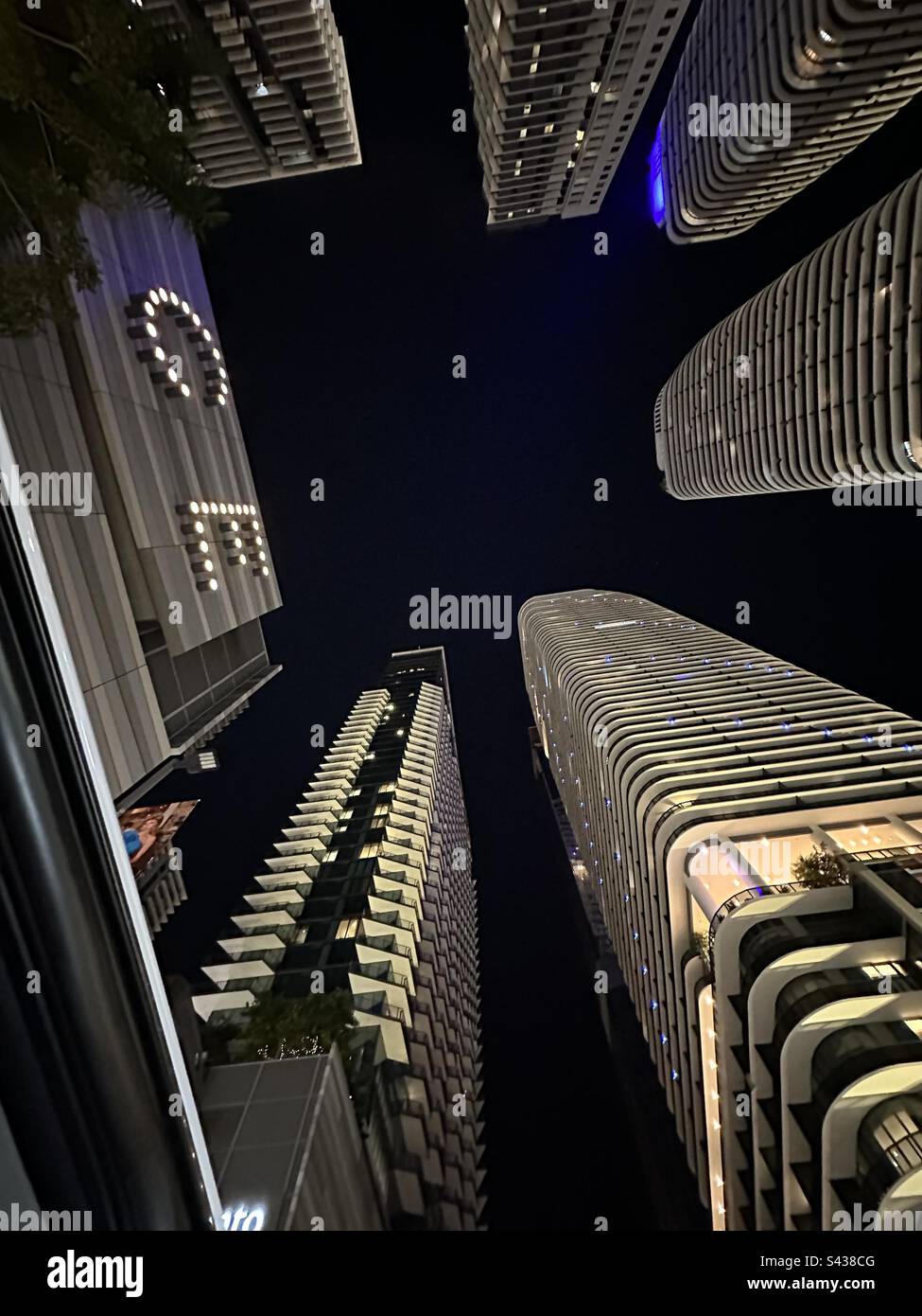 Looking up at tall building at night in Miami the other city that never sleeps - Smartphone Captured Stock Image