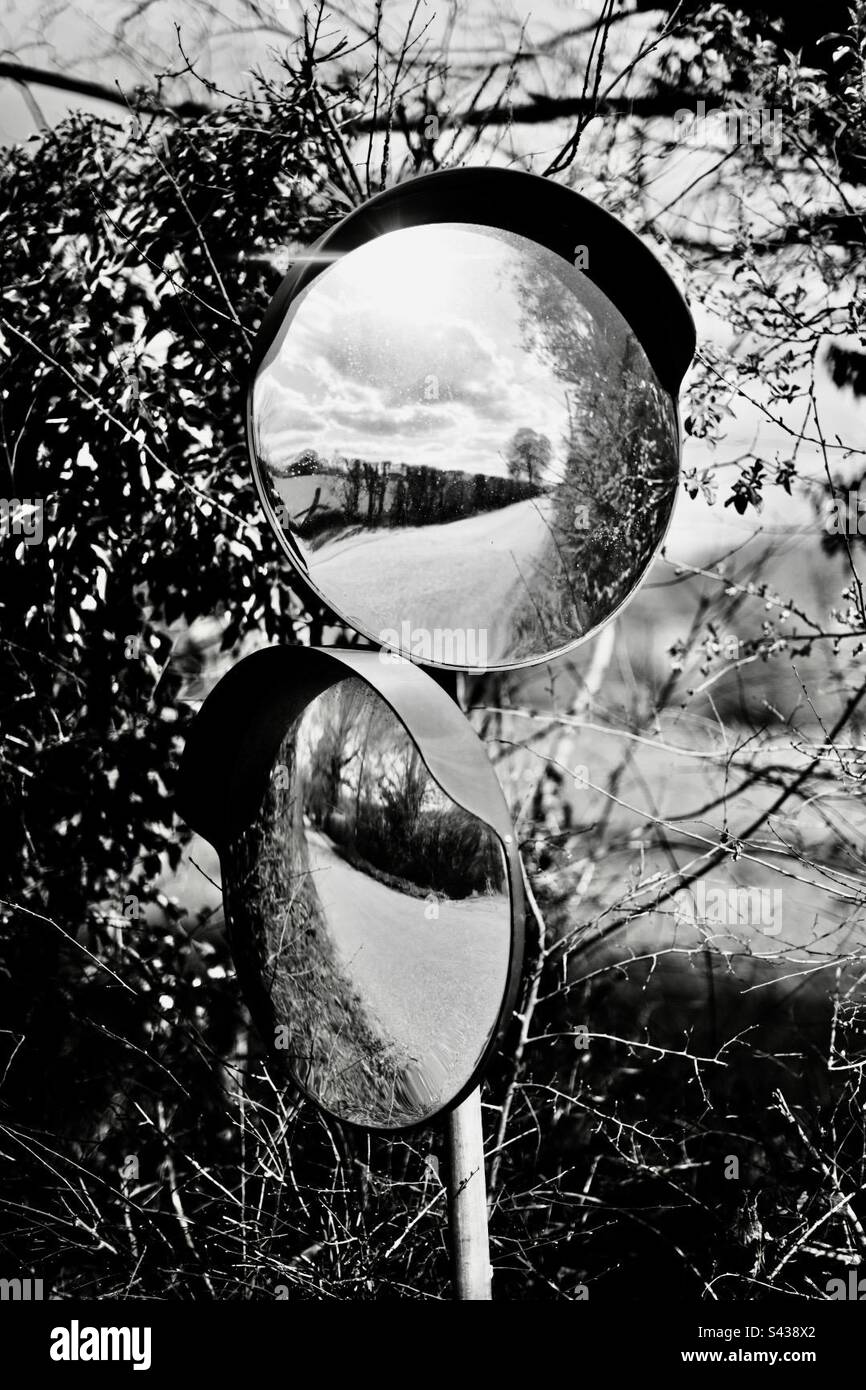 Two convex mirrors to check the road is clear in both directions - Smartphone Captured Stock Image