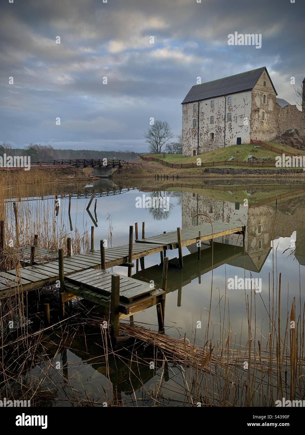 The beautiful ancient castle of Kastelholm in the Åland Islands archipelago in the Baltic Sea region of Finland in autumn. Viewed over a decaying pier on an inland sea lake - Smartphone Captured Stock Image The beautiful ancient castle of Kastelholm in the Åland Islands archipelago in the Baltic Sea region of Finland in autumn. Viewed over a decaying pier on an inland sea lake - Smartphone Captured Stock Image