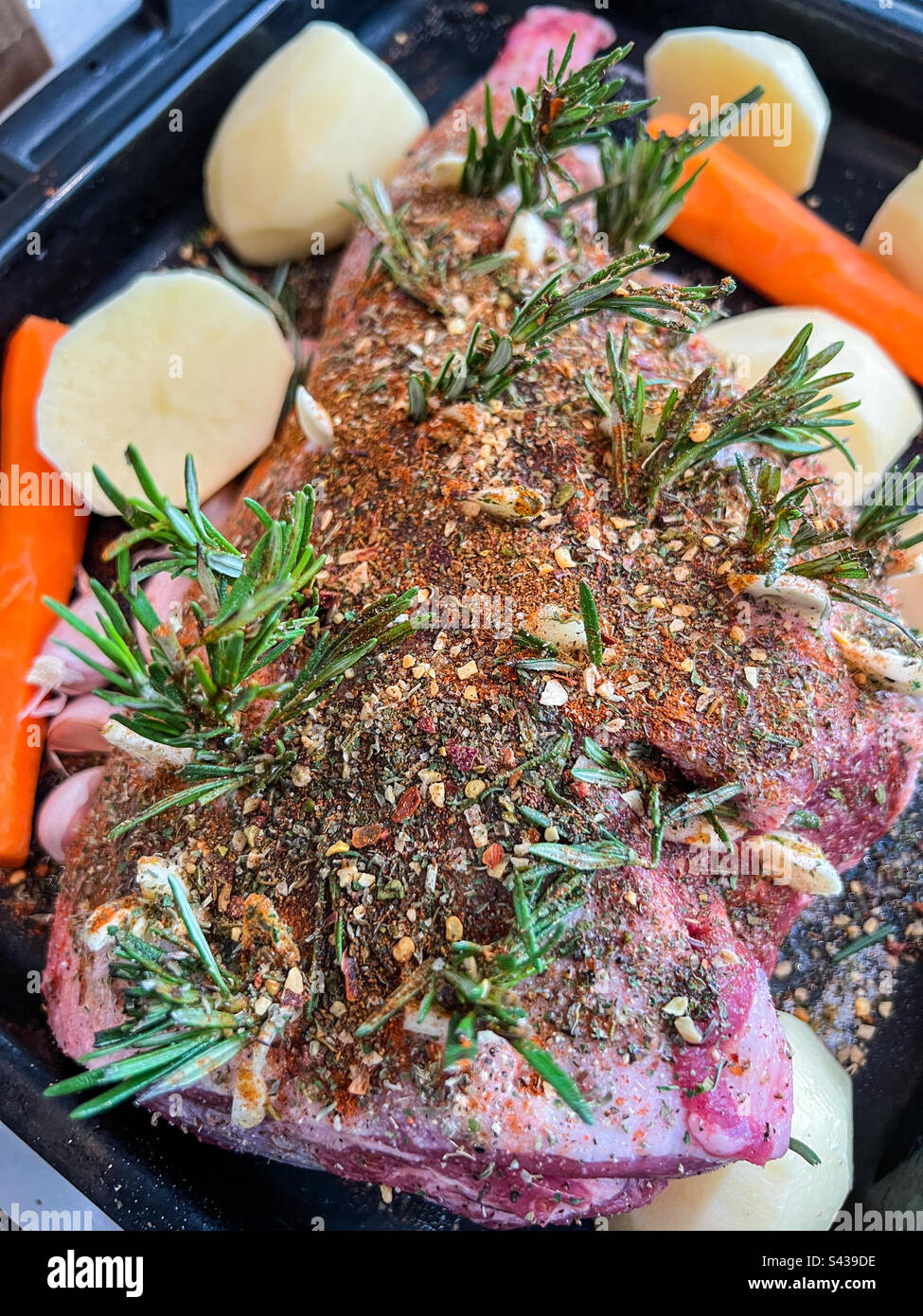 Leg of lamb before cooking with herbs and spices Stock Photo Alamy
