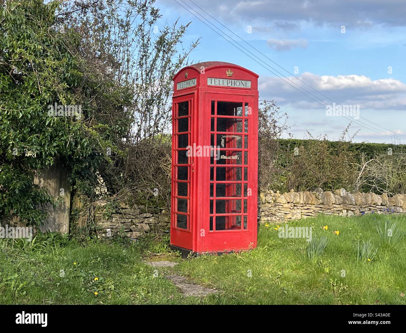 Red telephone box in Cotswold village Stock Photo Alamy