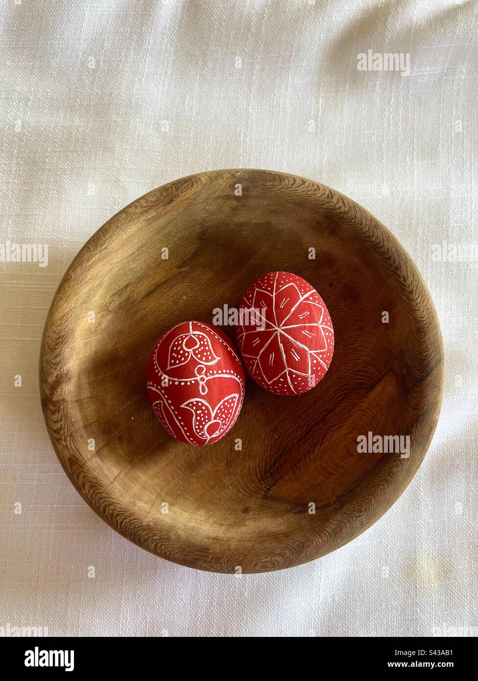 Two 2 dyed painted eggs in wooden plate for Easter Stock Photo