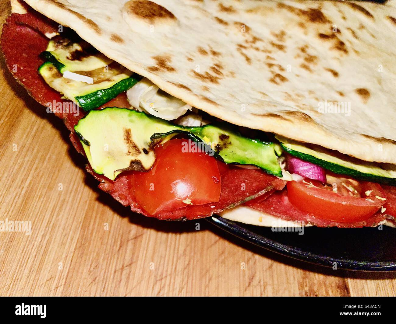 Italian piadina unleavened flat bread stuffed with vegetables and cured