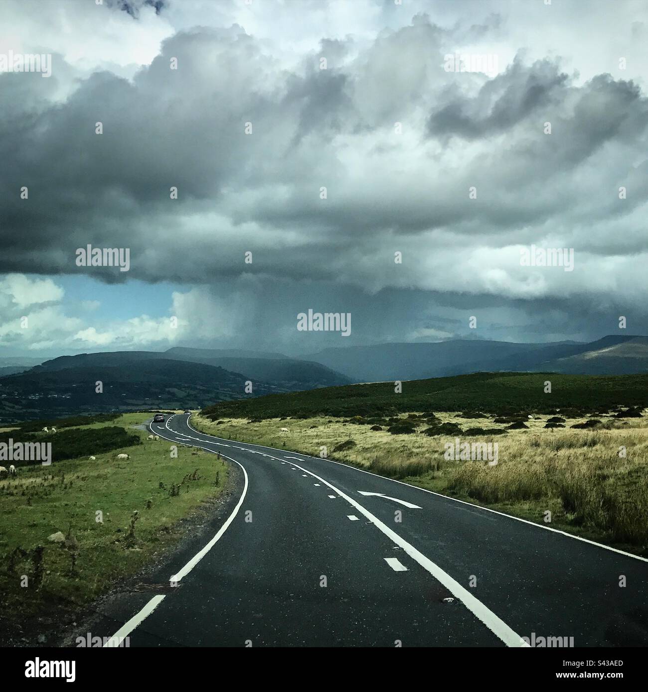 A dramatic mountain road in the Brecon Beacons region of Wales in the UK a popular tourist destination for walkers and outdoor pursuits - Smartphone Captured Stock Image