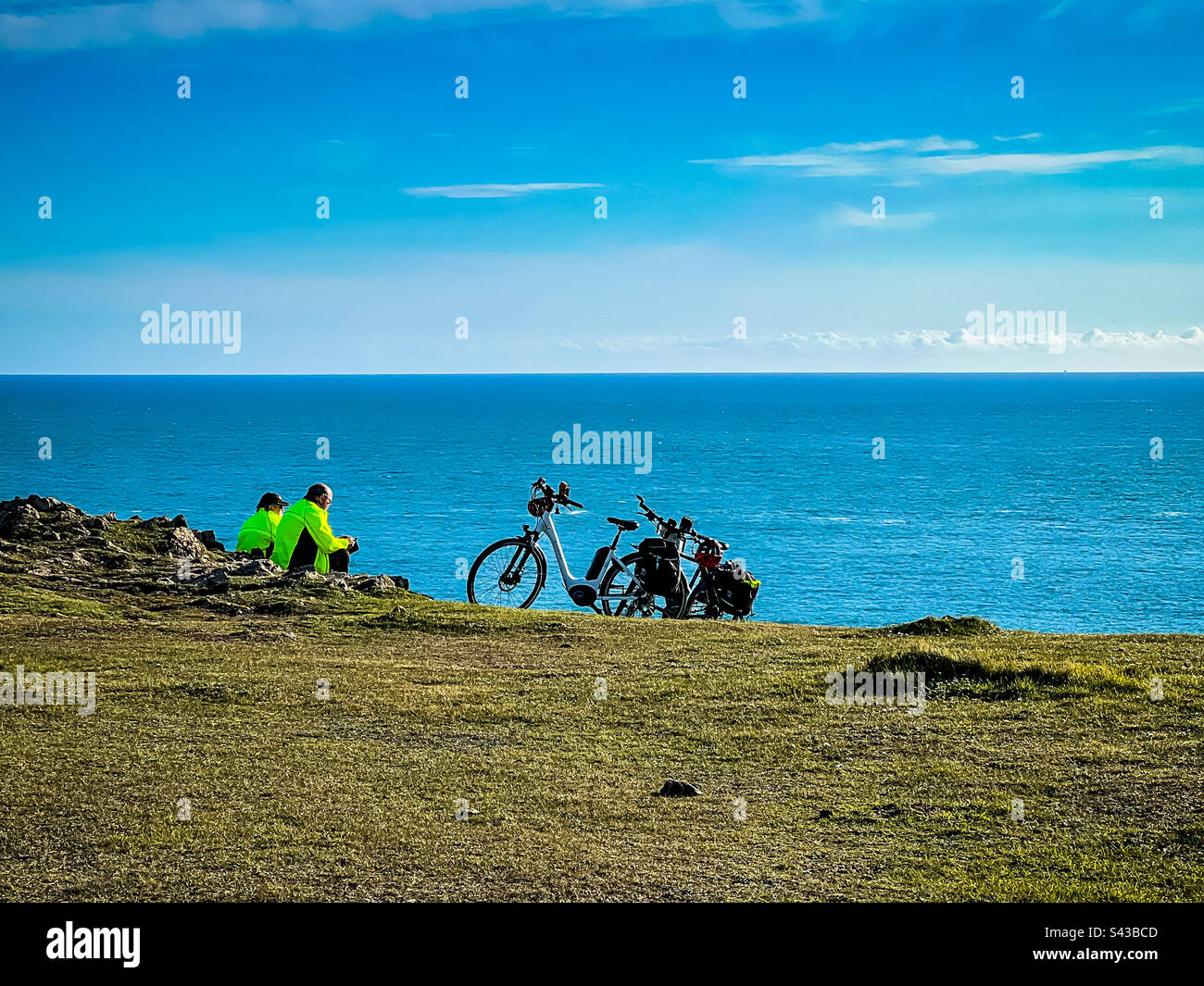 Cyclists enjoying a break at Lizard Point, Cornwall, UK - April 8th, 2023 - Smartphone Captured Stock Image