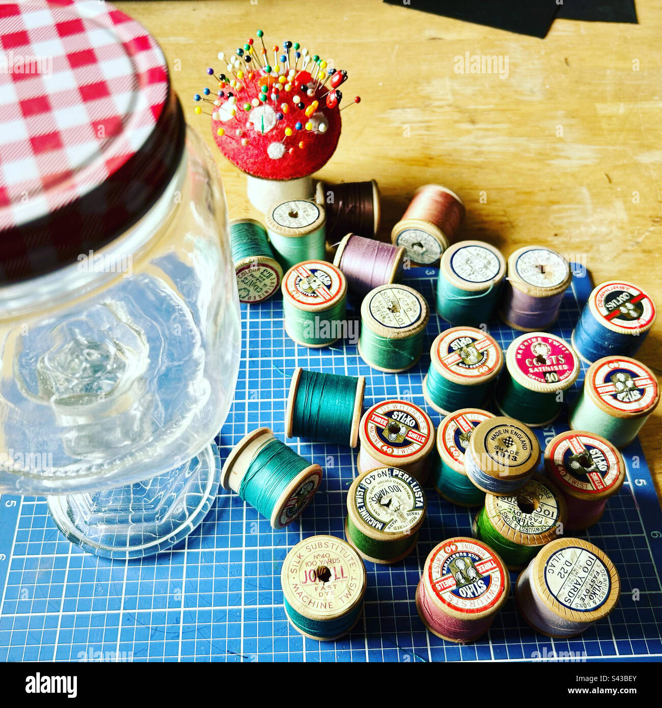 Old cotton reels and mushroom pin cushion - Smartphone Captured Stock Image