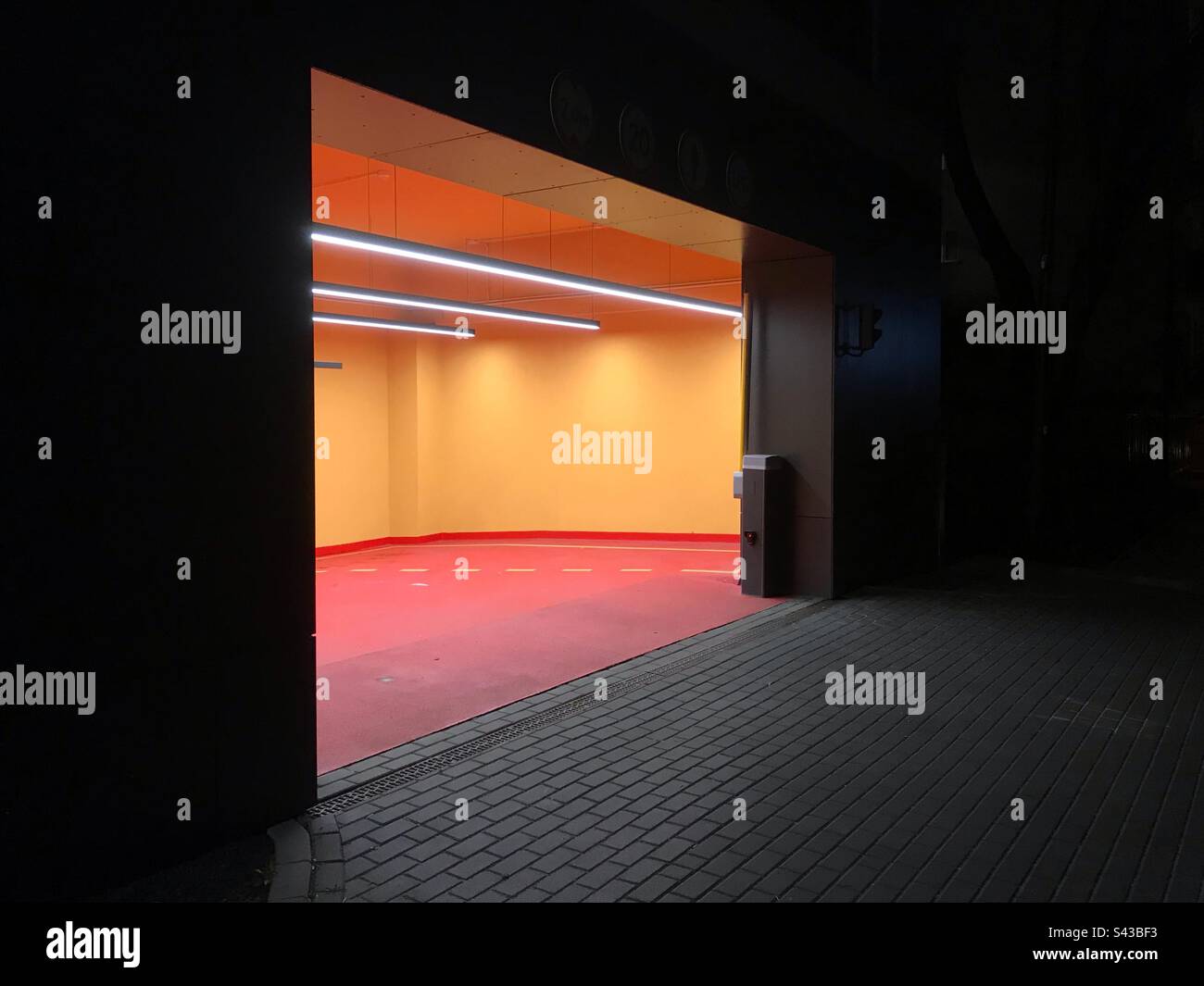 Colourful entrance to an underground car park at night in Warsaw Poland - Smartphone Captured Stock Image