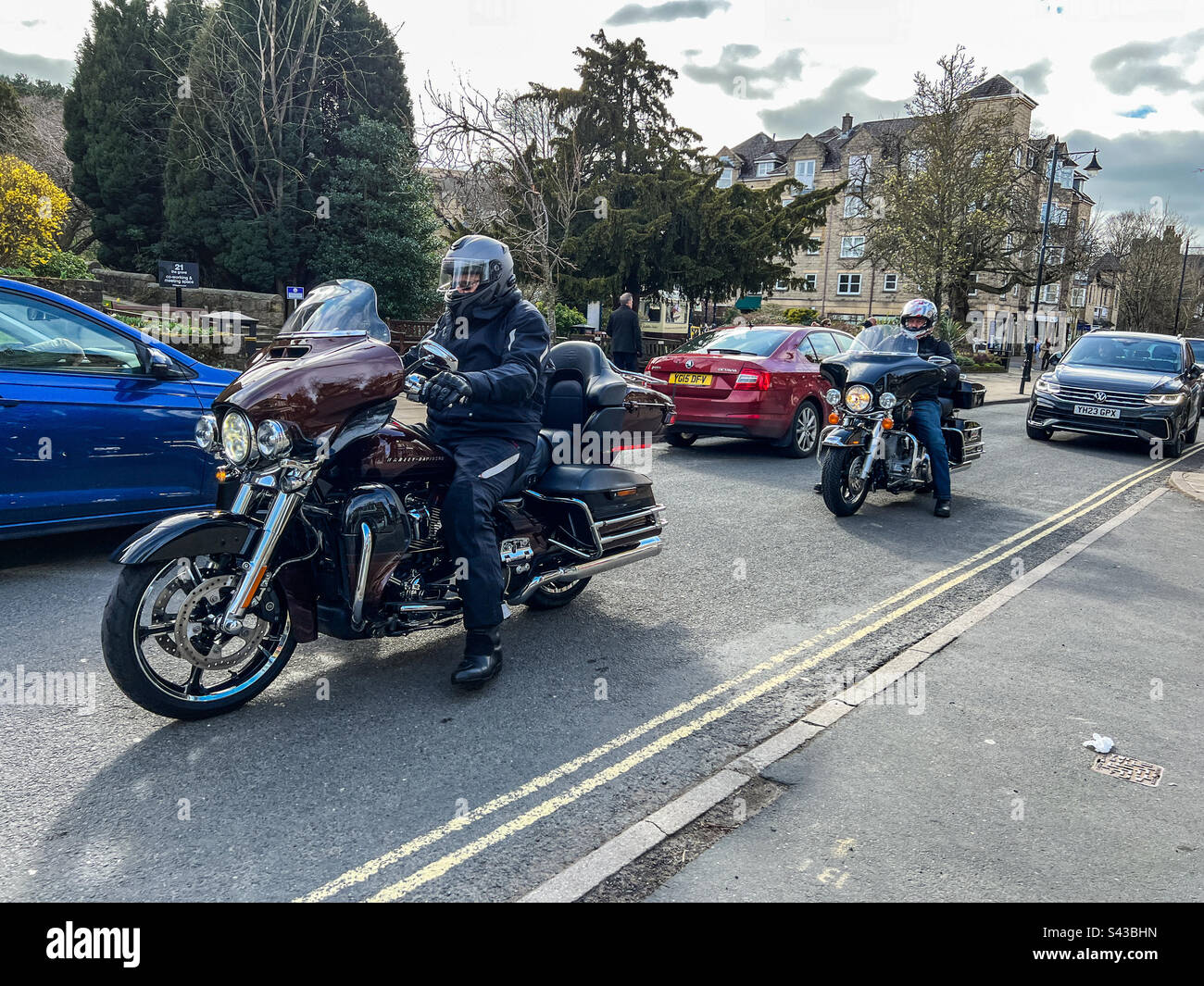 Harley Davidson Electra glide ultra motorcycles driving through Ilkley town centre - Smartphone Captured Stock Image