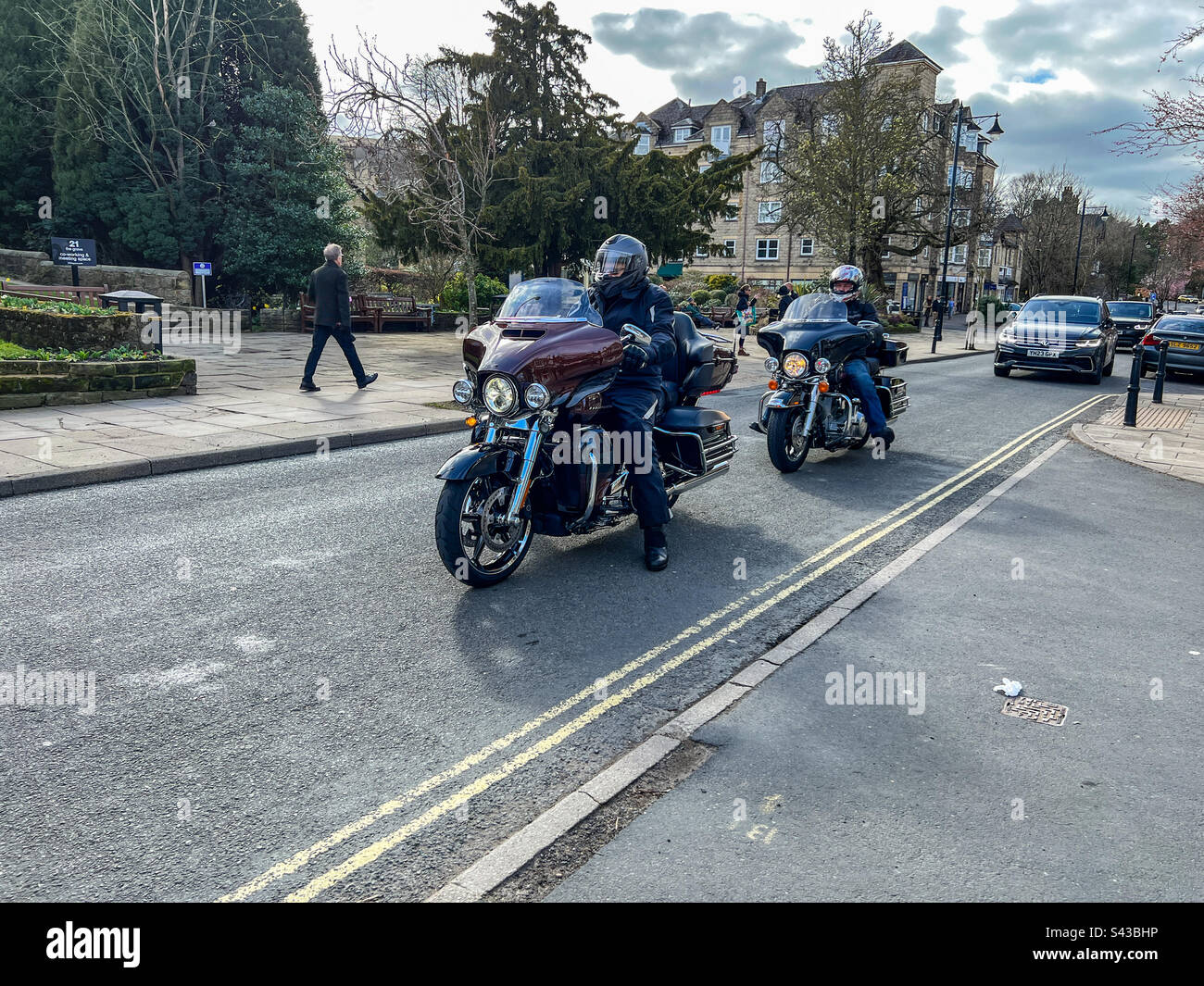 Harley Davidson Electra glide ultra motorcycles driving through Ilkley town centre - Smartphone Captured Stock Image
