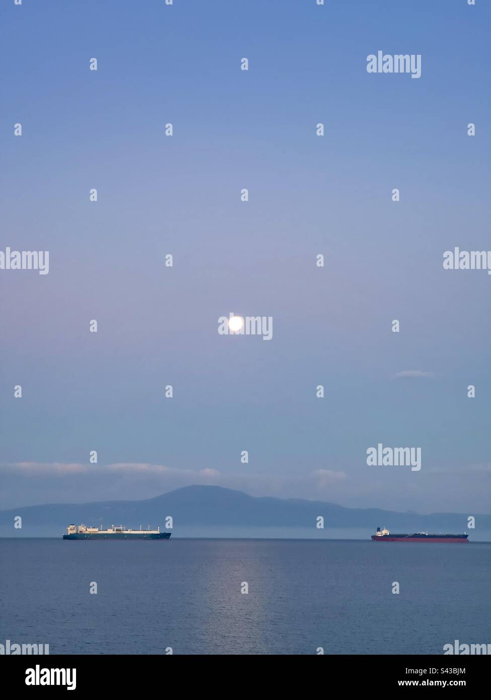 Two boats and the moon in Kalamata Bay - Smartphone Captured Stock Image