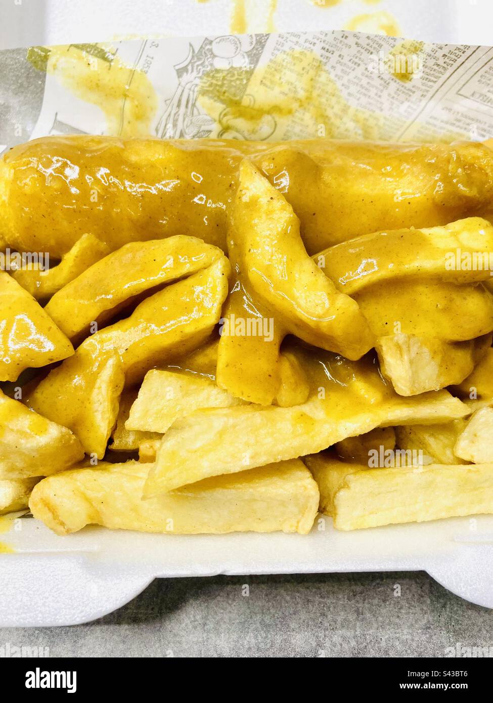Chips curry sauce and battered sausage Stock Photo Alamy