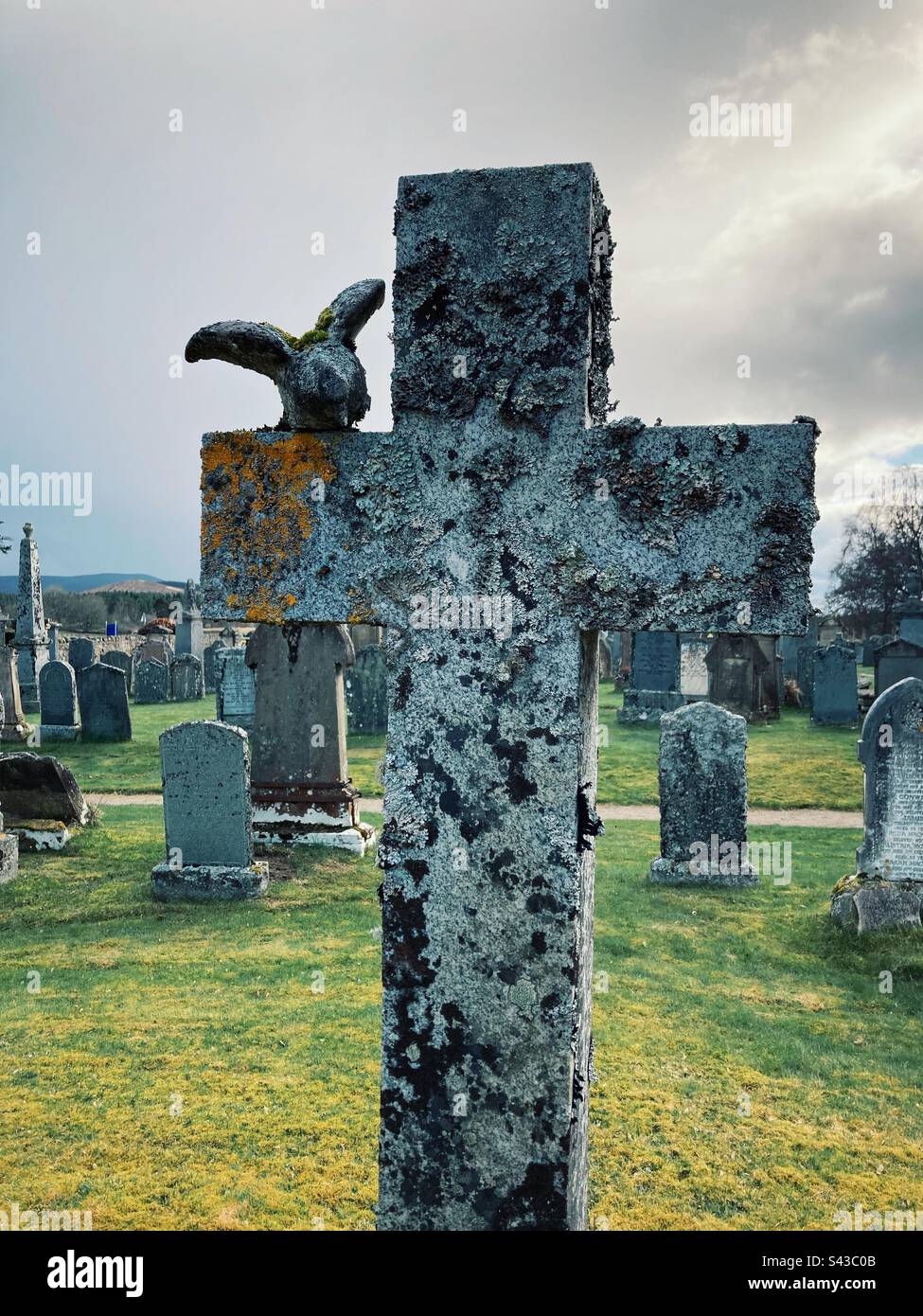 Grave stone in form of a cross in Cromdale churchyard, Scotland - Smartphone Captured Stock Image Grave stone in form of a cross in Cromdale churchyard, Scotland - Smartphone Captured Stock Image