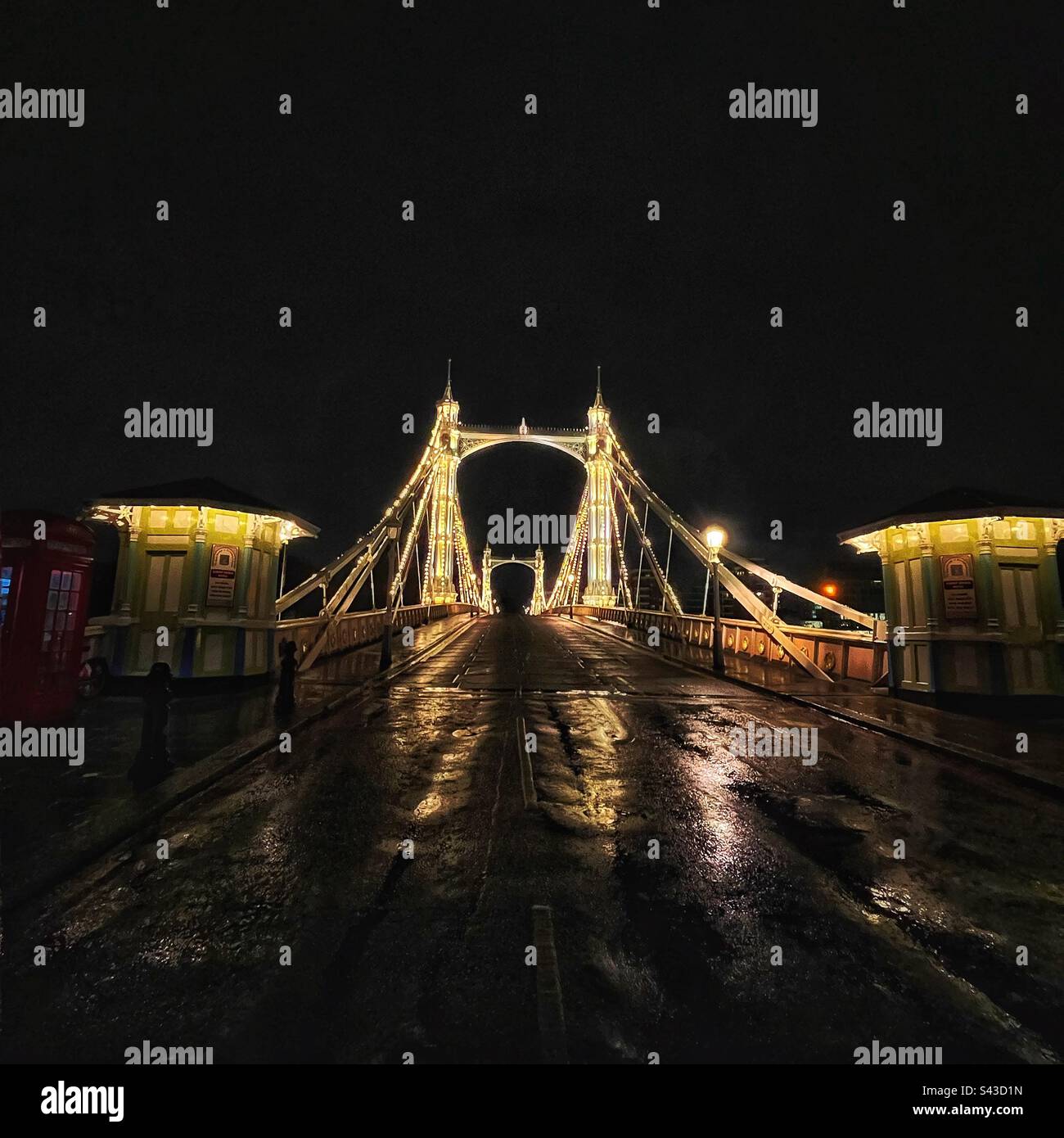 THE ALBERT BRIDGE - Chelsea to Battersea crosses the river Thames. One of London’s oldest suspension bridges and illuminated at night. Grade II Listed, modified in 1973 by the GLC for safety reasons - Smartphone Captured Stock Image