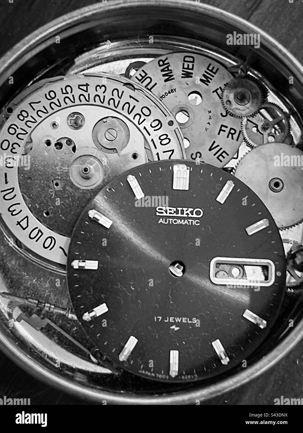 Parts of a disassembled antique Seiko wristwatch, lots of dials, fears
