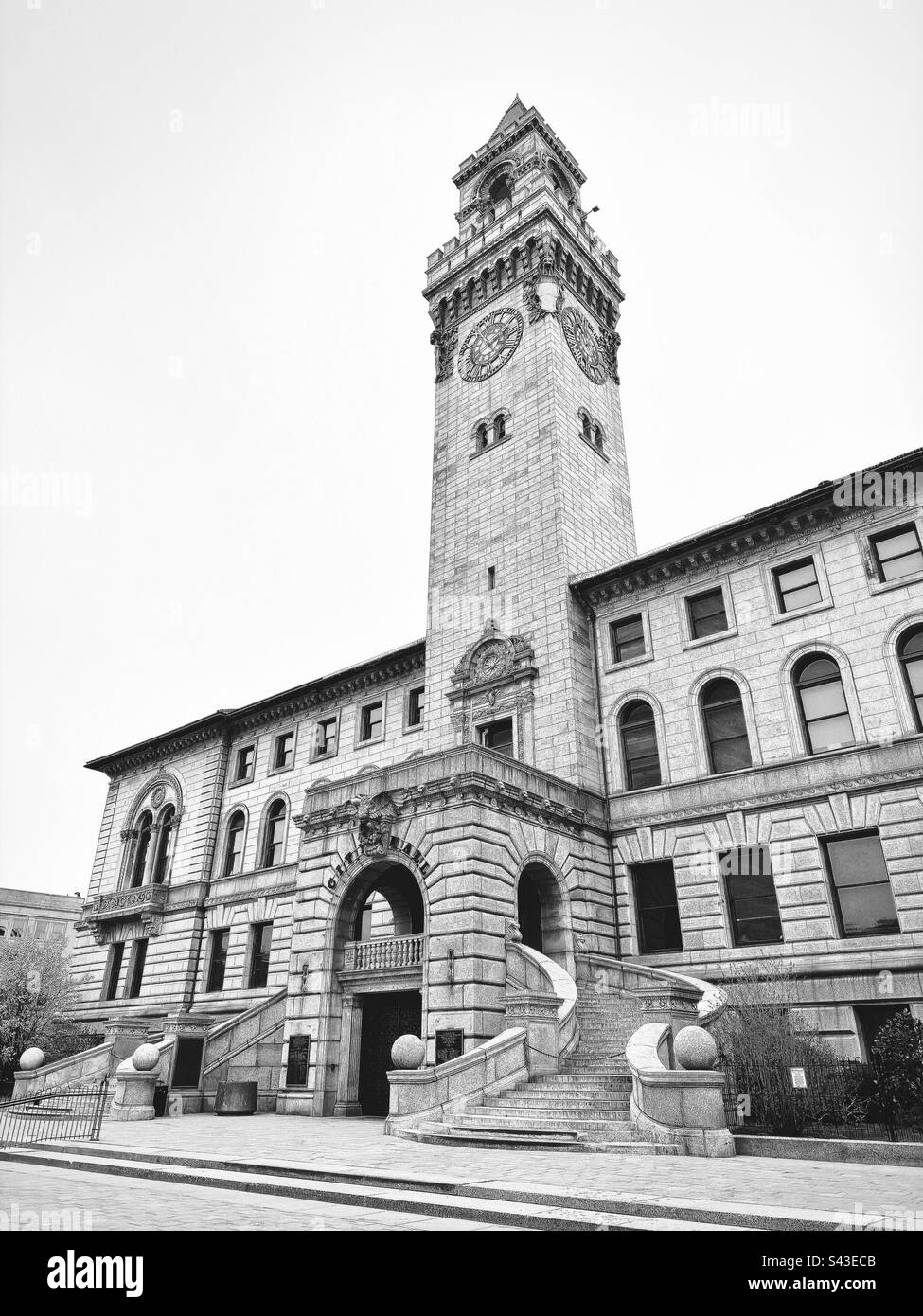 Side view of Worcester City Hall with steps, entrance, and tower. In Worcester, Massachusetts, USA. Black and white filter. Italianate building from 1898. - Smartphone Captured Stock Image