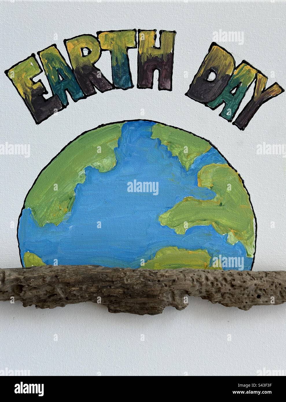 My personal hand painted Earth Day concept with petrified beach wood - Smartphone Captured Stock Image