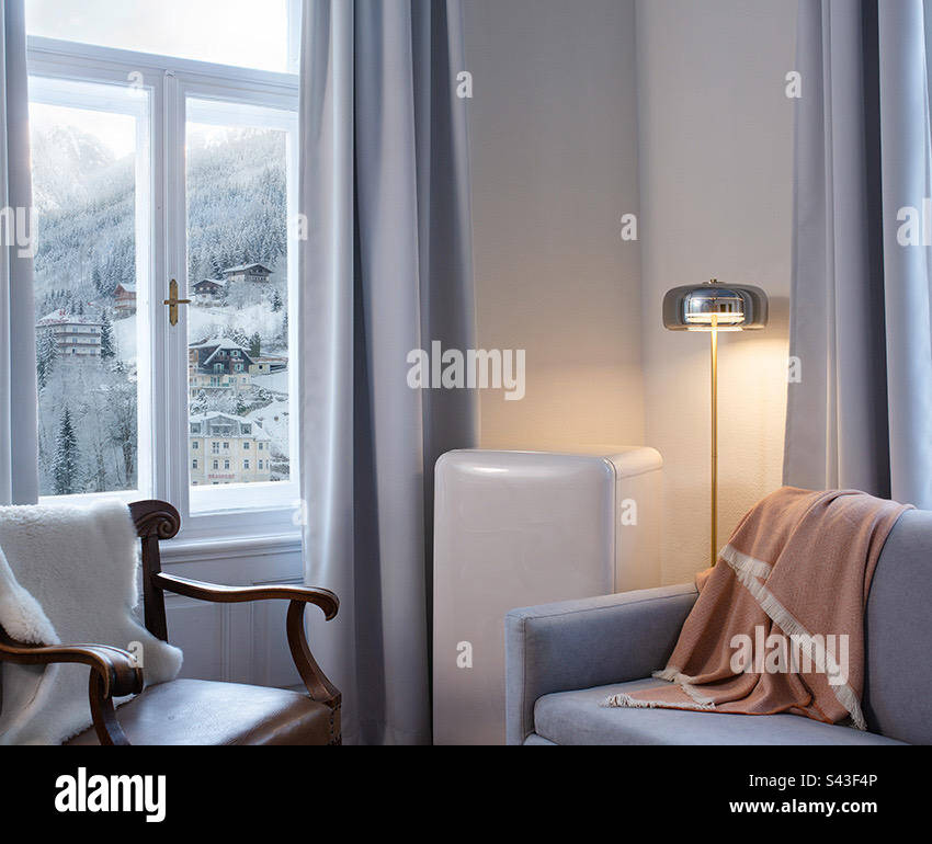 A modern designed living room space in a snowy winter setting. - Smartphone Captured Stock Image