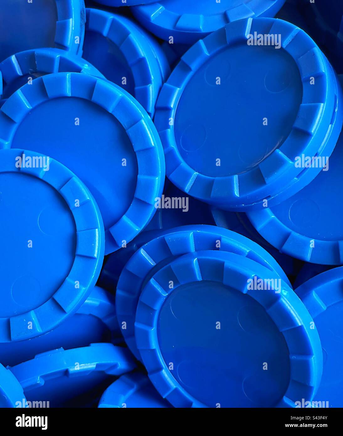 Blue counters or ‘chips’ in a pile, close up. Stock Photo