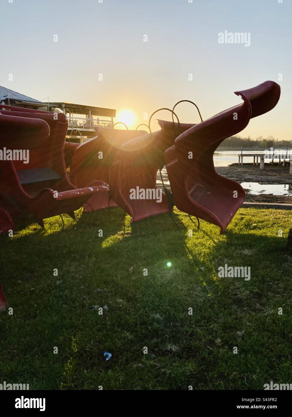 A pile of winter sleds with the sun rising over top. - Smartphone Captured Stock Image