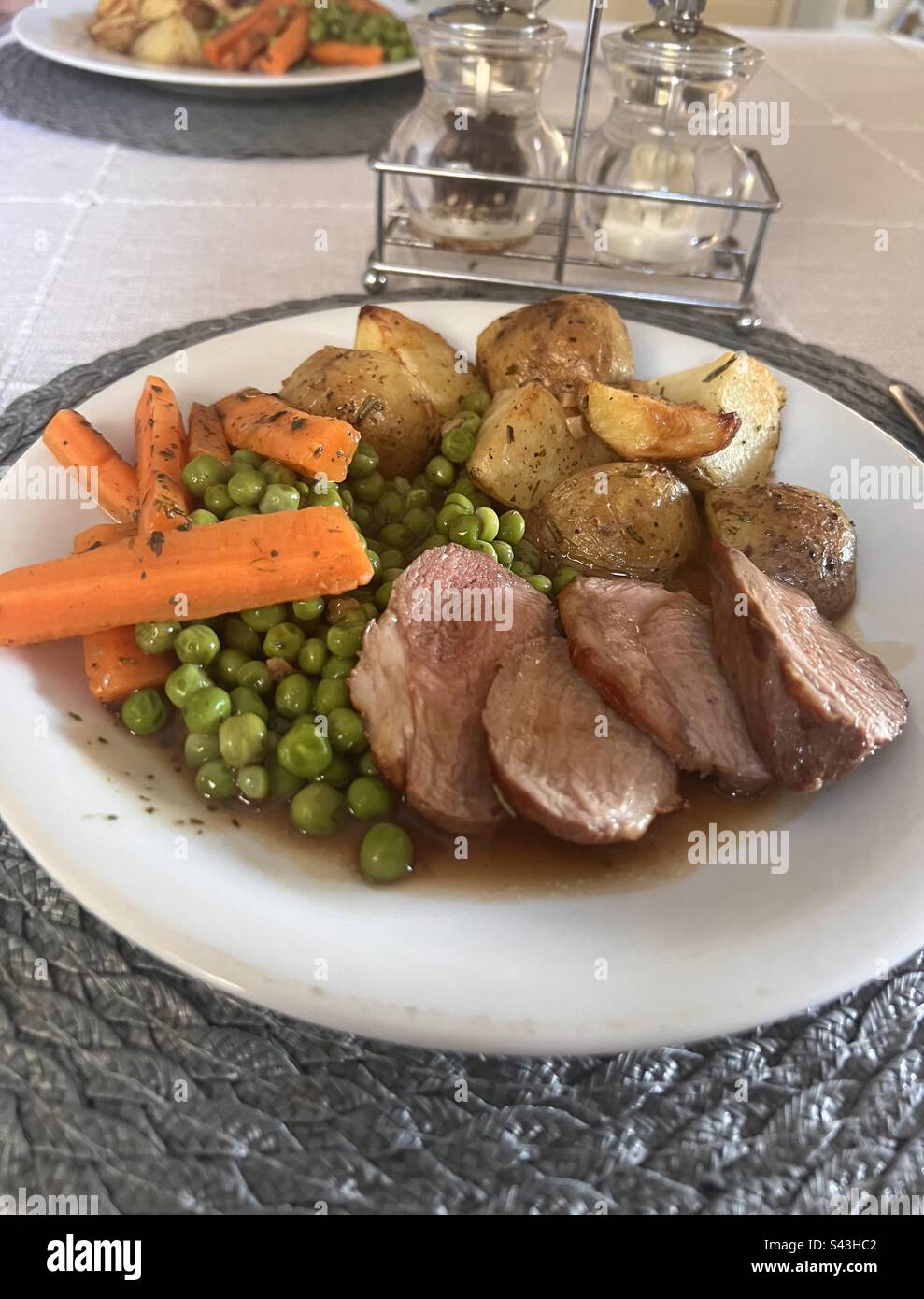 Roast lamb and rosemary potatoes and minted carrots and peas Stock