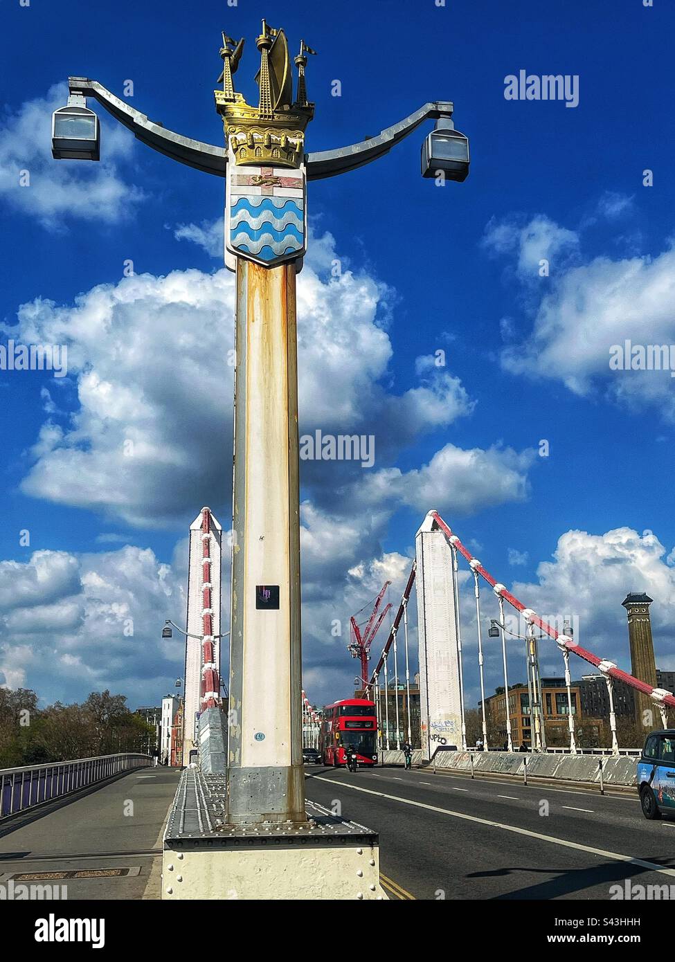 Chelsea Bridge across the river Thames from the south bank. The coat of arms of the London County Council 1889 to 1965, on a lamppost - Smartphone Captured Stock Image