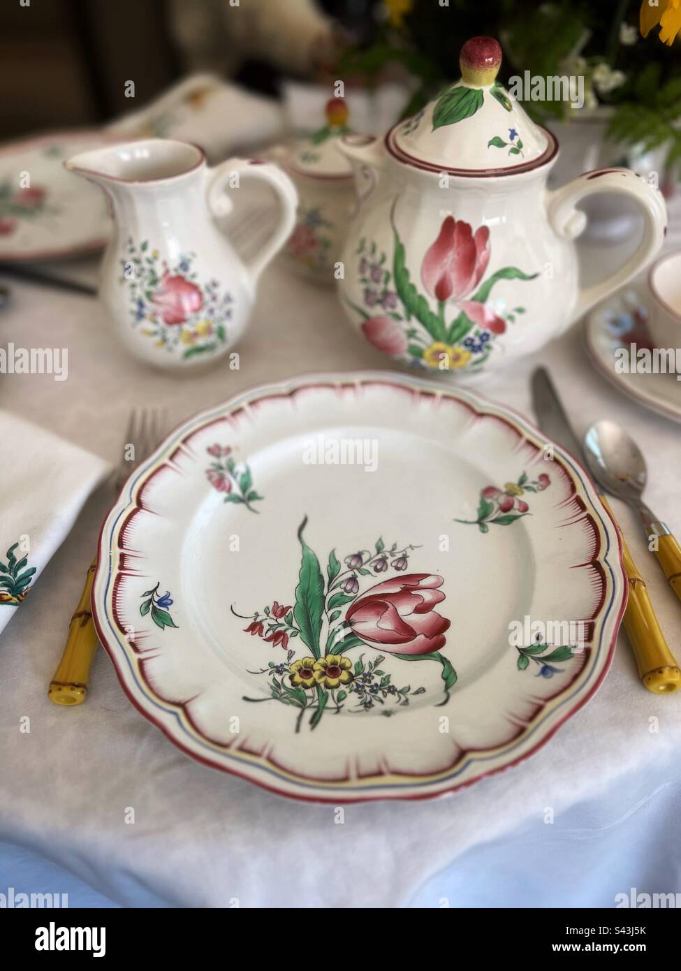 Table setting of pretty floral porcelain dishes - Smartphone Captured Stock Image