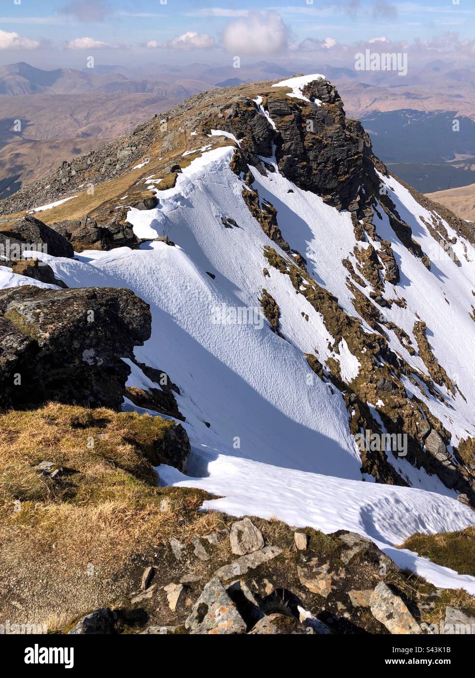 The summit of Ben Lui, with a view of Coire Gaothach holding the snow, Tyndrum Scotland Stock Photo