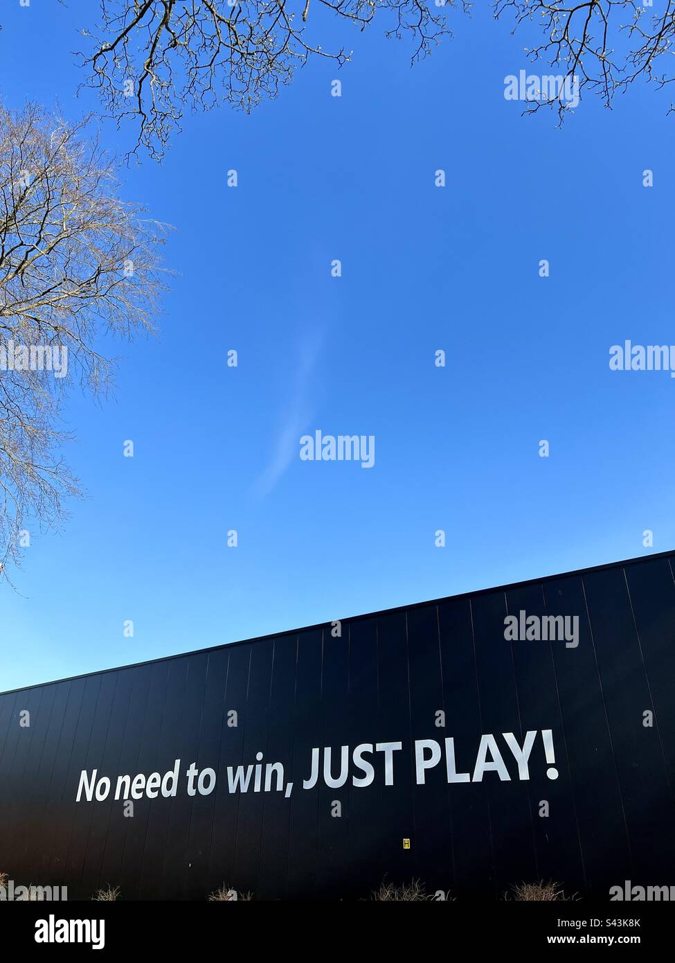 No need to win just play. Writing on black wall at sports arena in witton Park, Blackburn. - Smartphone Captured Stock Image