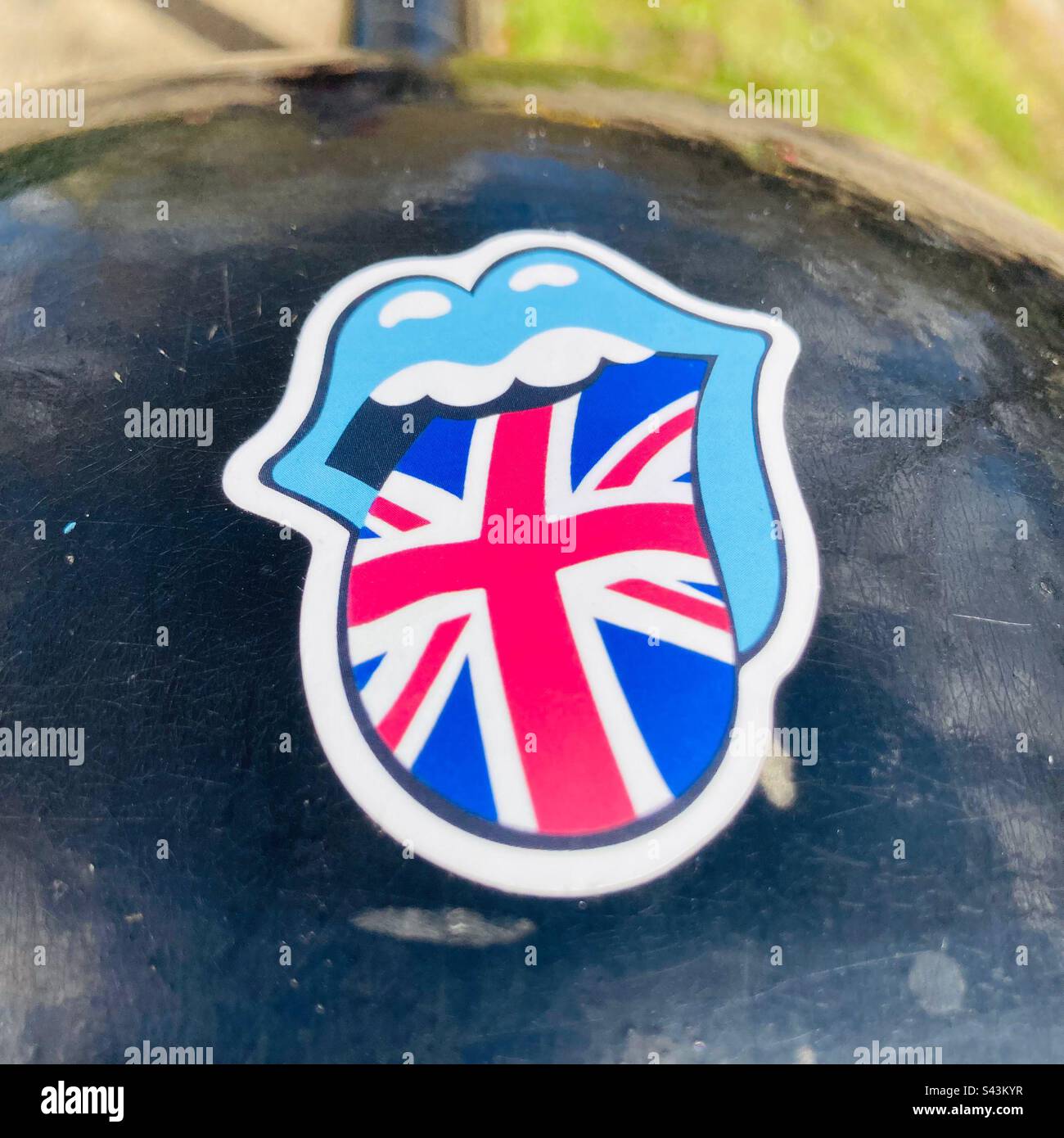 A sticker of an open mouth with a tongue sticking out that shows the Union Jack, London, England - Smartphone Captured Stock Image