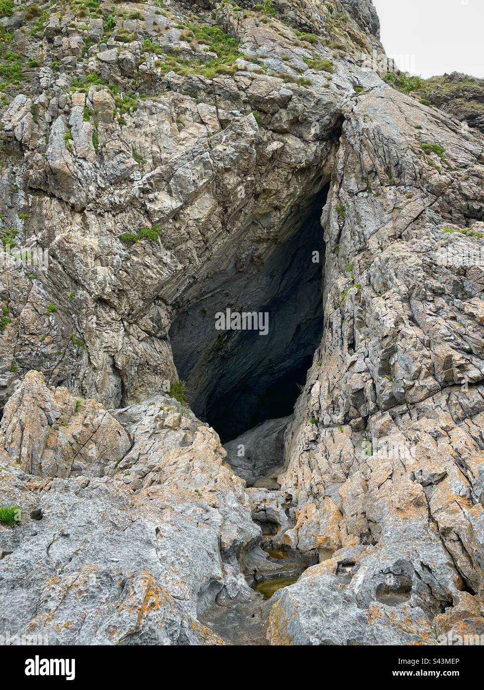 The entrance to Paviland cave (Goat’s hole cave), South Gower, Swansea, Wales. Stock Photo