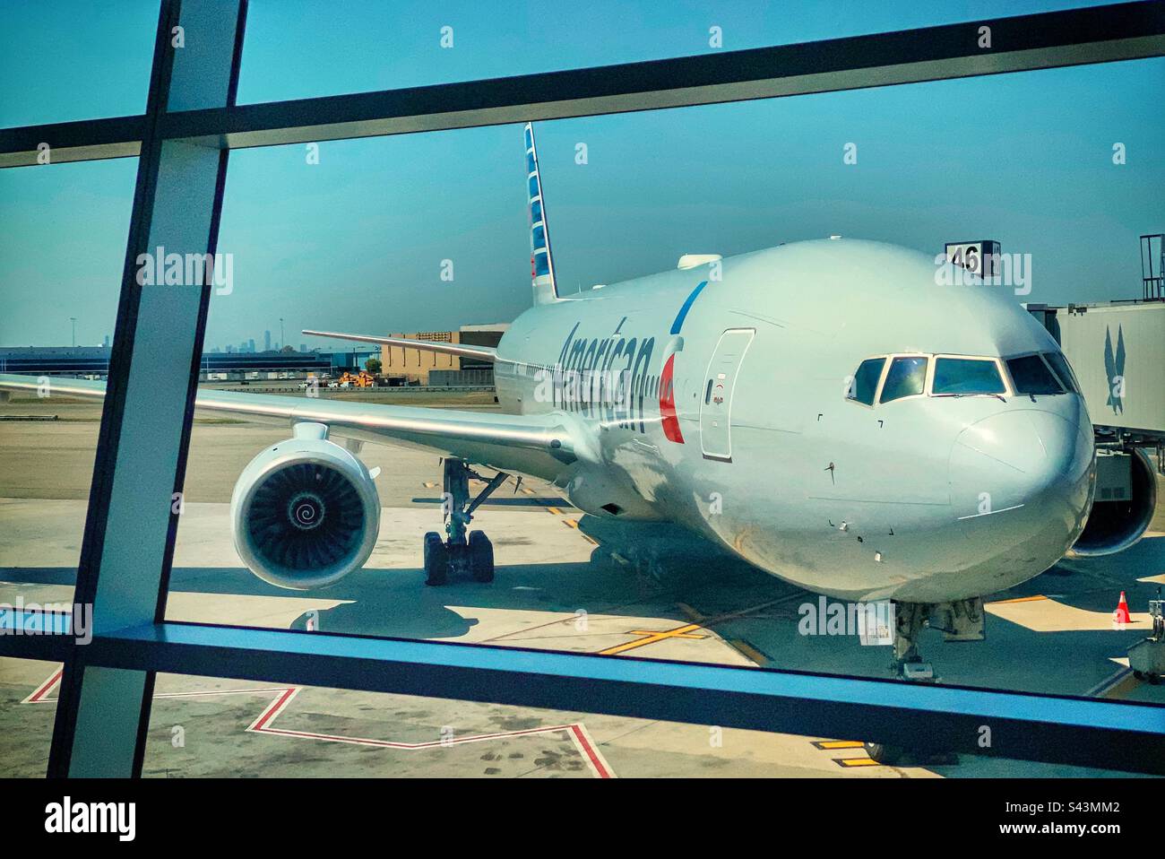 An American airlines plane sits at a gate in terminal 8 at JFK John F