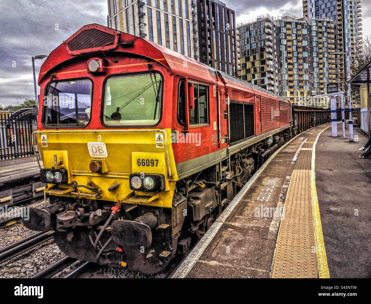 Heavy goods train passing through Lewisham Station Stock Photo