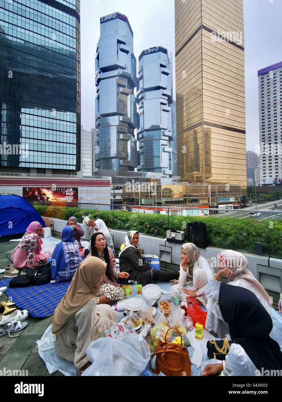 Indonesian domestic helpers relaxing in Tamar park on their Sunday off