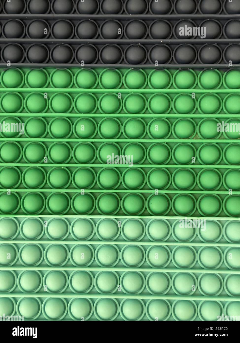 Abstract back of green and black rubber circles and lines - Smartphone Captured Stock Image