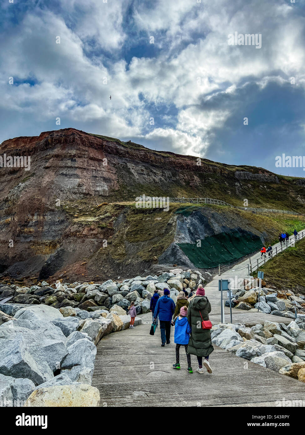Walking from Whitby pier up the rocky path - Smartphone Captured Stock Image