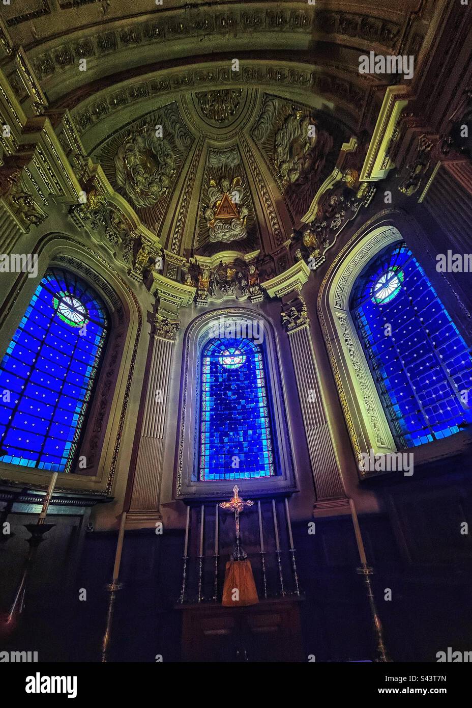 Looking at the altar and the cross at St Mary le Strand Church in London - the blue stained glass windows and ornate plaster work - Smartphone Captured Stock Image